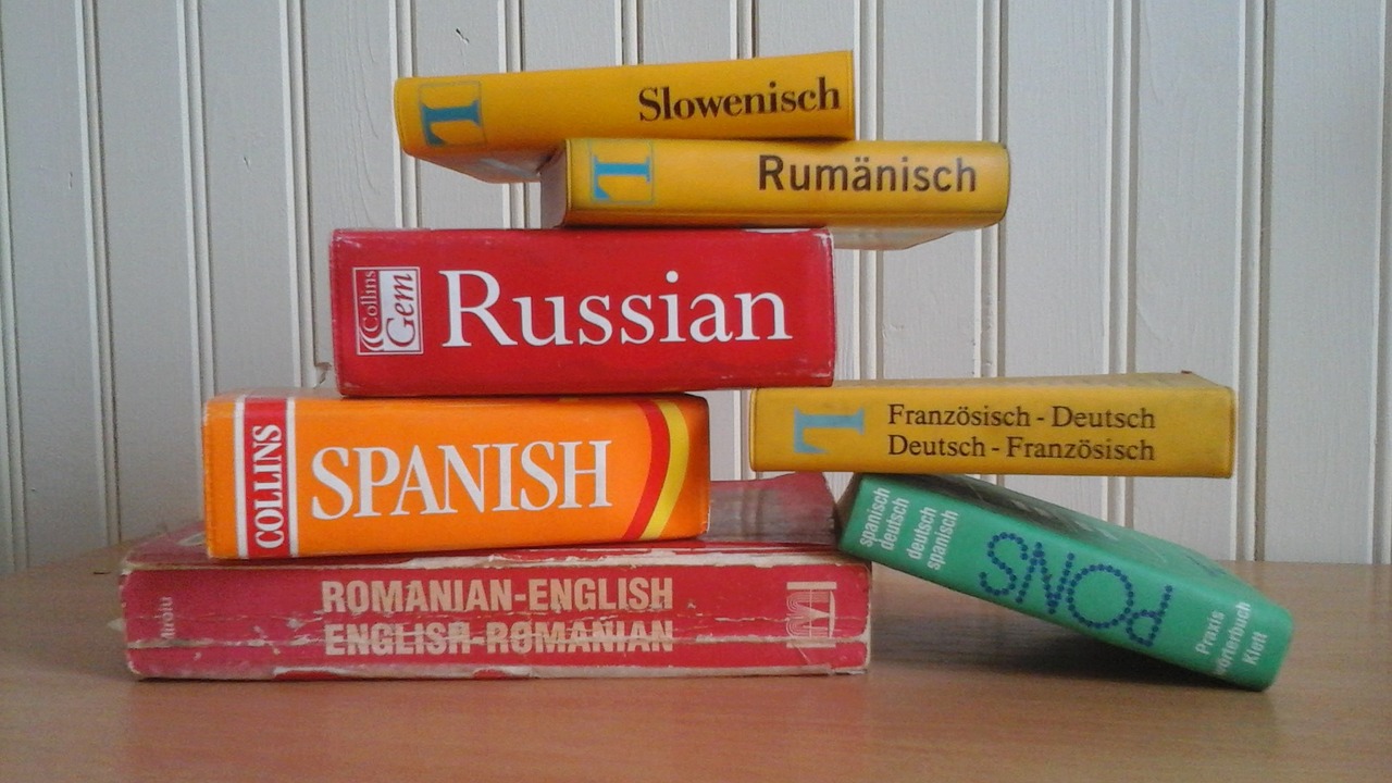 A treasure trove of knowledge. A stack of language dictionaries, representing the depth and richness of language learning